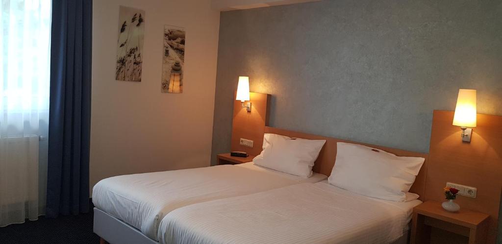 Postel nebo postele na pokoji v ubytování Hotel Beuss