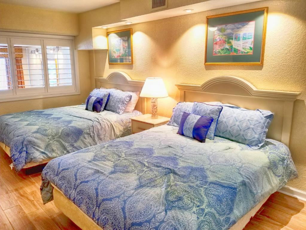 a bedroom with two beds and a lamp in it at Luxurious Ocean Front Views from this 8th Floor Beach Retreat! in Myrtle Beach