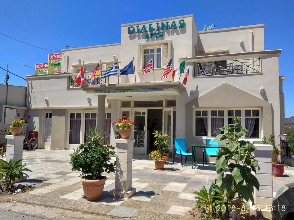 a white building with flags in front of it at Dialinas Apartments in Istro