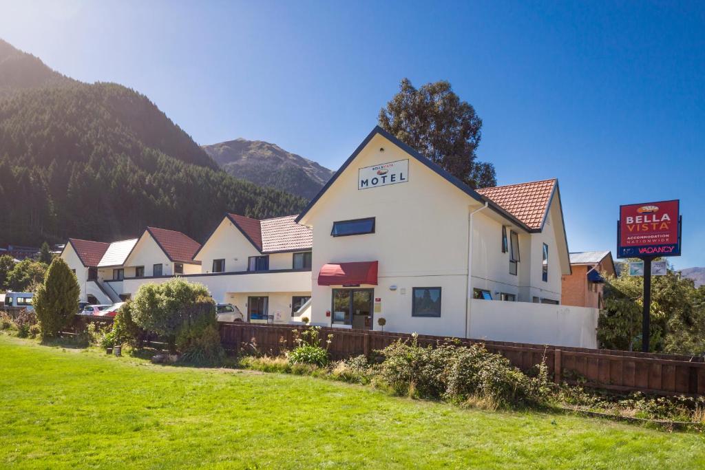 a hotel with a sign in front of a building at Bella Vista Queenstown in Queenstown