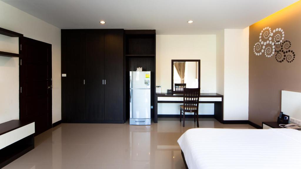 Postel nebo postele na pokoji v ubytování Phavina Hotel Rayong SHA Extra Plus