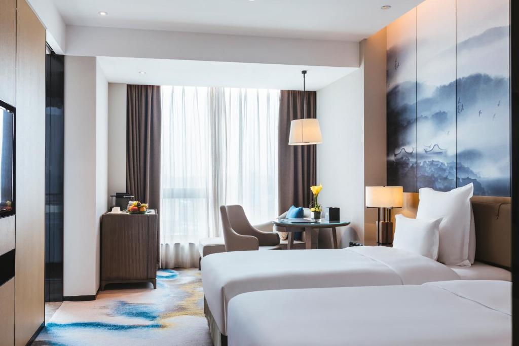 Postel nebo postele na pokoji v ubytování Pullman Fuzhou Tahoe