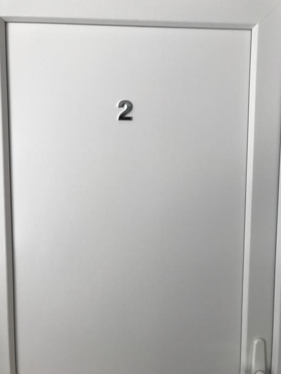 a white door with the number two on it at Vila de lux in Bela Crkva