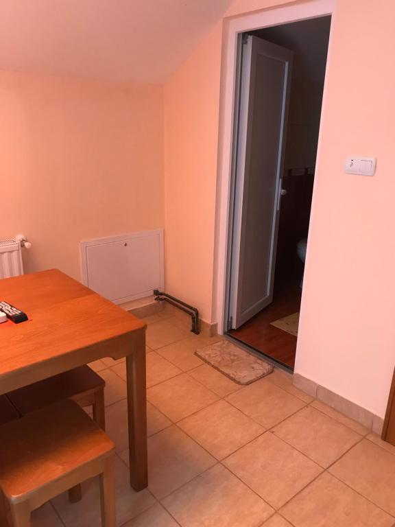 a room with a table and an open door at Vila de lux in Bela Crkva