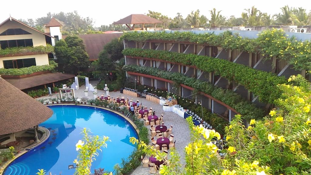 a hotel with a swimming pool and a resort at Uday Suites - The Airport Hotel in Trivandrum