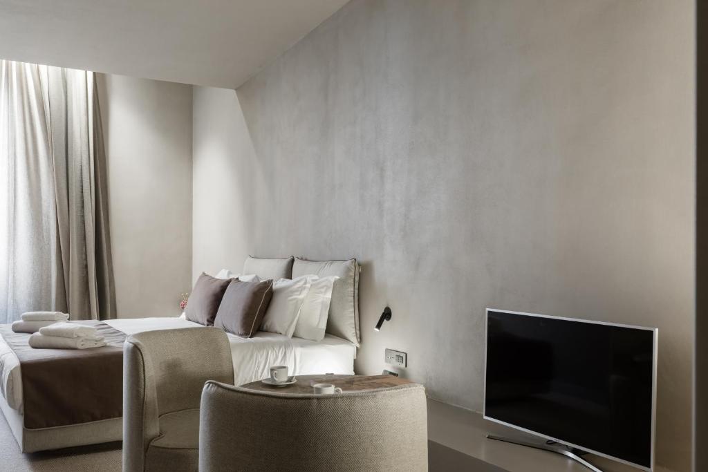 Televízia a/alebo spoločenská miestnosť v ubytovaní Elysium Suites collection