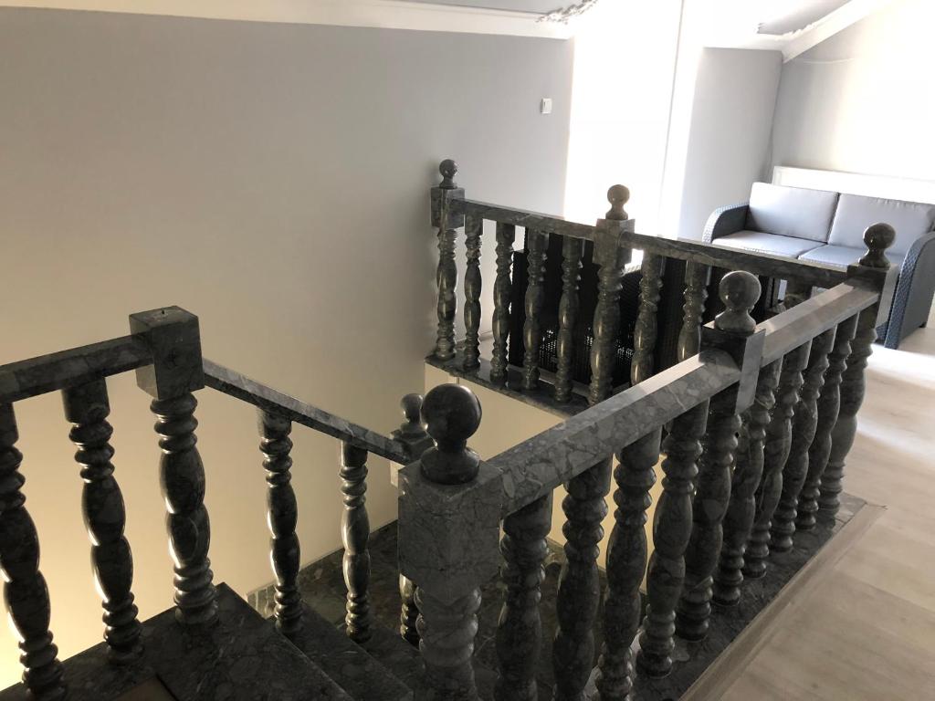 a staircase in a living room with a couch at Vila de lux in Bela Crkva