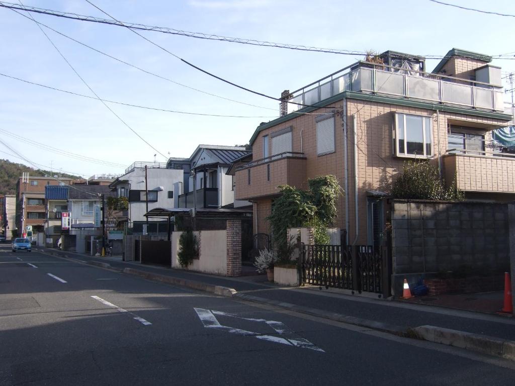 eine leere Straße mit Häusern am Straßenrand in der Unterkunft tomy&tetu in Kyoto