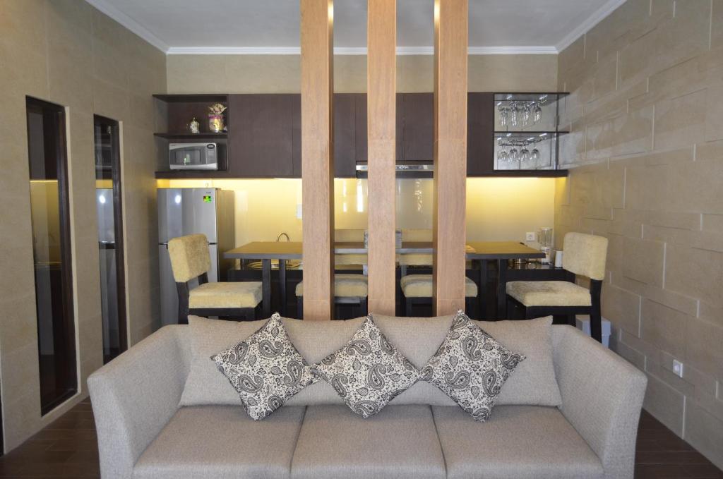 a living room with a couch with pillows on it at Puri Bintang in Nusa Dua