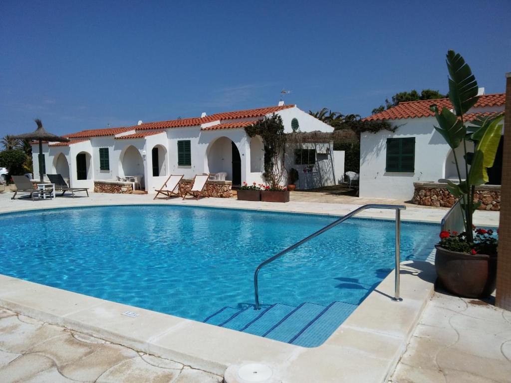 a swimming pool in front of a house at Nure Cel Blau in Cala en Bosc