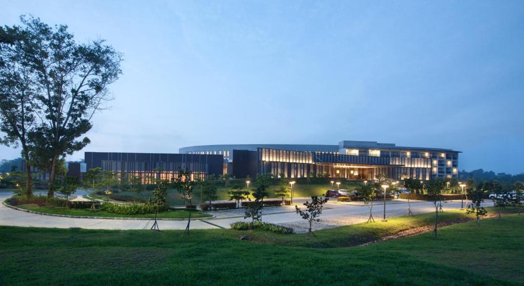 a large building with lights in front of it at Hotel Santika Premiere Bandara Palembang in Palembang