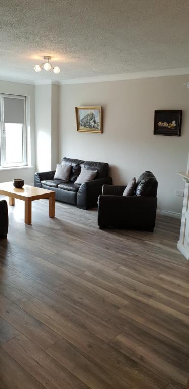 a living room with two couches and a coffee table at Galway City Centre Apartment, Augustine Street in Galway