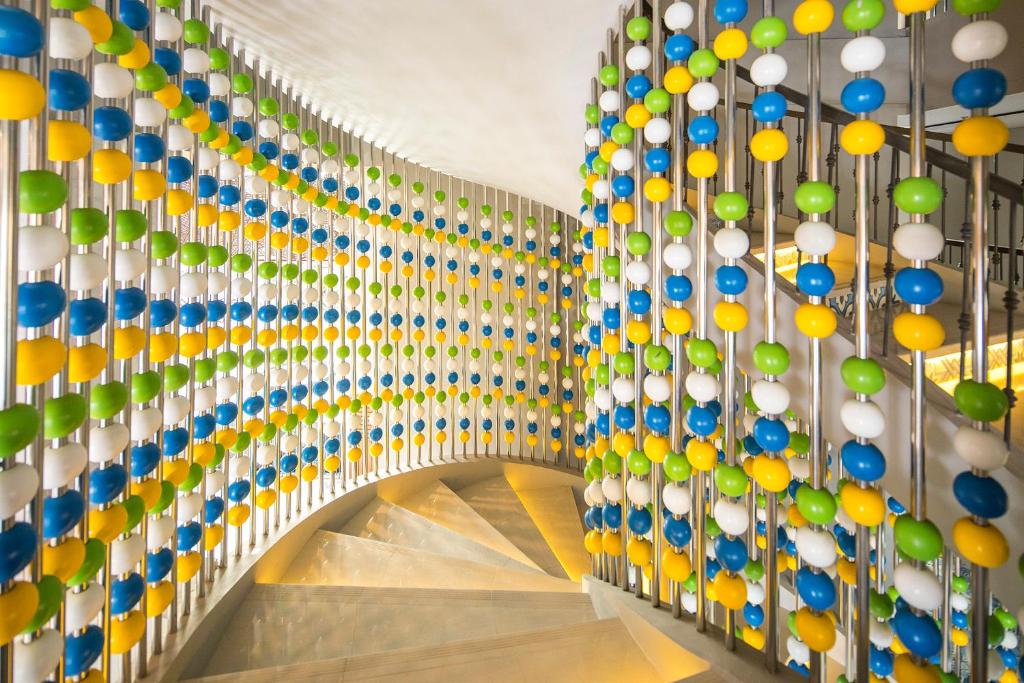 a hallway with colorful balls on the wall at Eastin Ashta Resort Canggu in Canggu