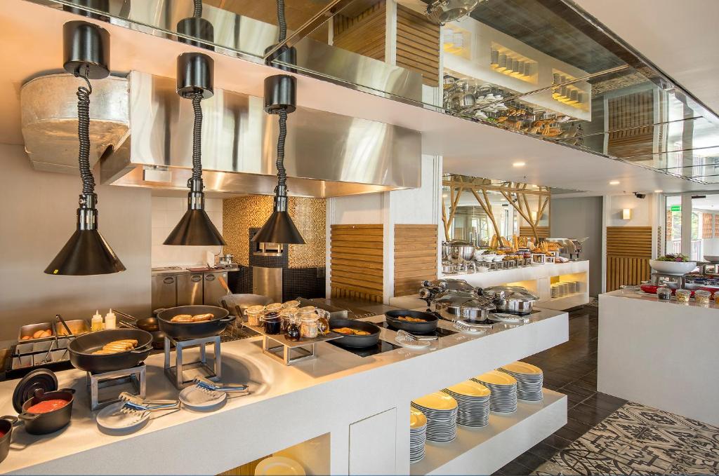 a kitchen with a counter with pots and pans at Eastin Ashta Resort Canggu in Canggu
