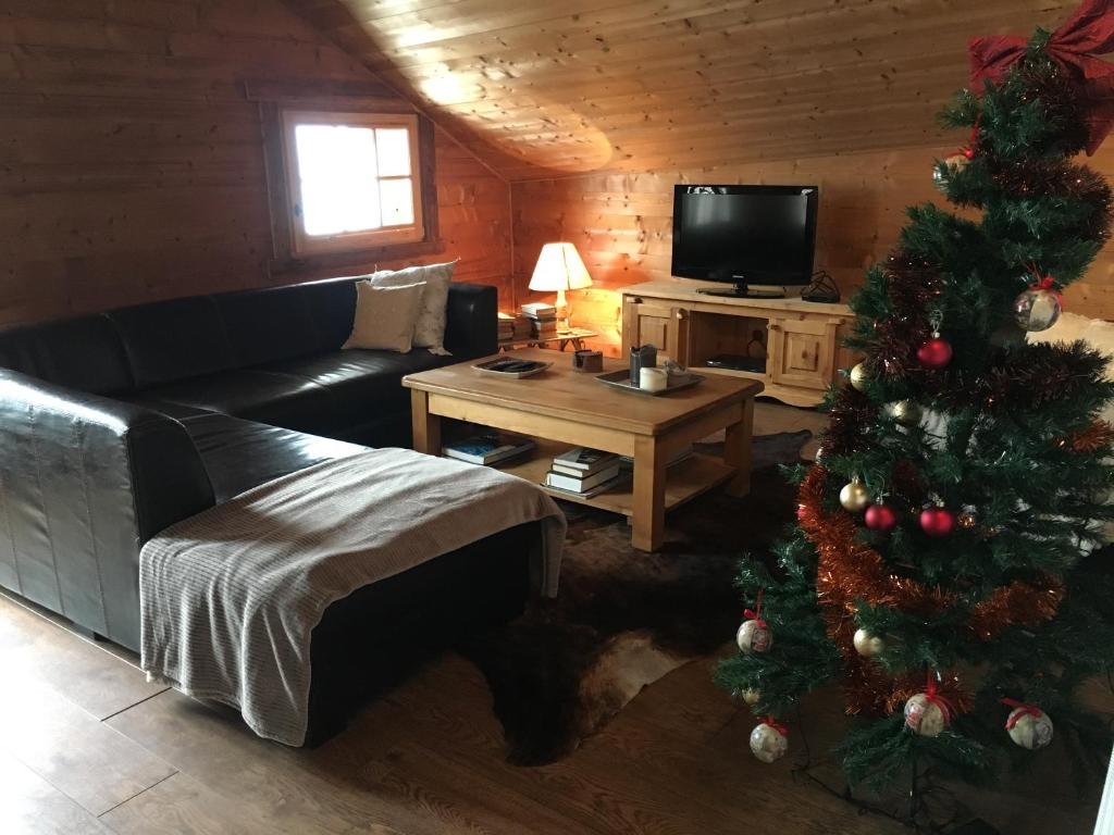 a living room with a christmas tree and a couch at Chalet Odette in Morzine