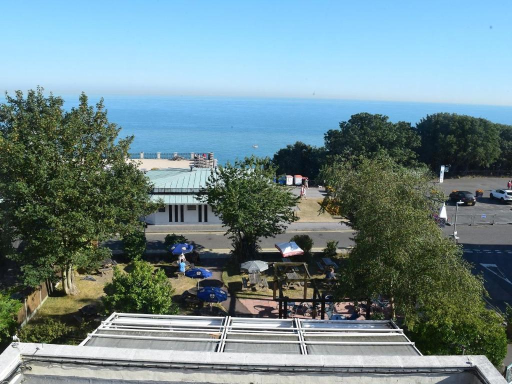 een uitzicht op een gebouw met een park en de oceaan bij The Portland Hotel in Folkestone