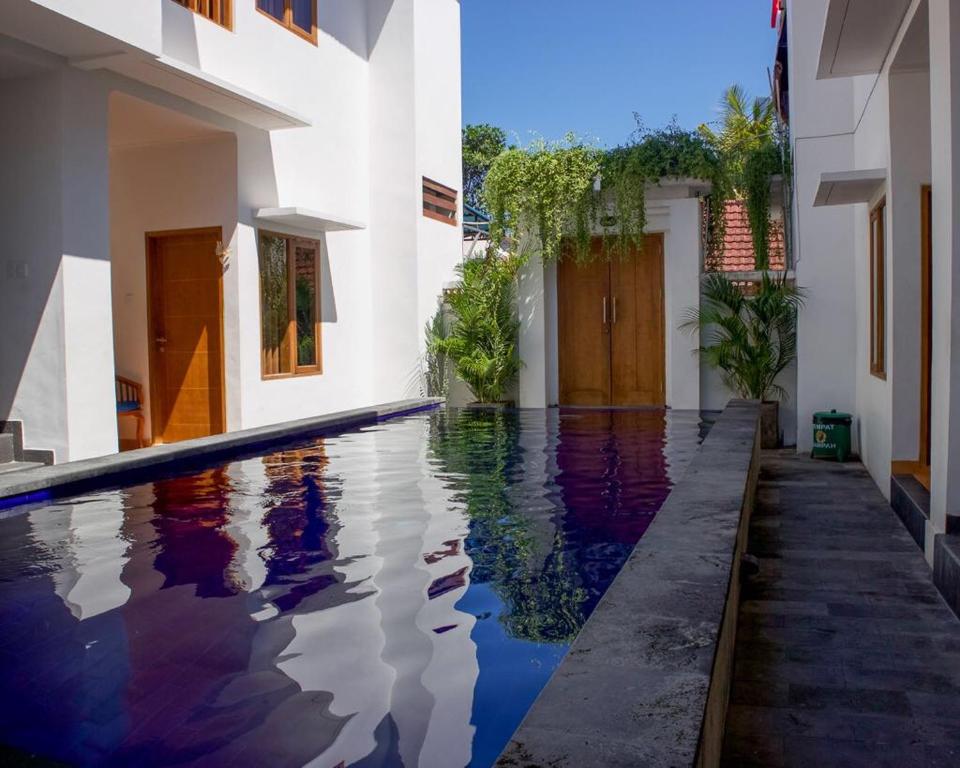 a swimming pool in the middle of a house at The Kayuri in Canggu