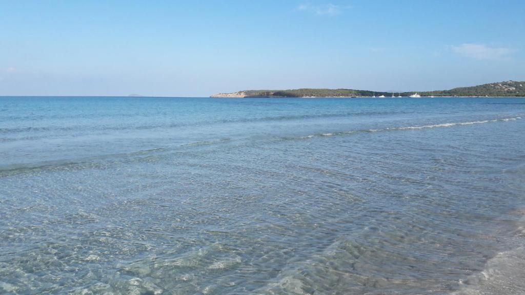 a body of water with a group of islands in the background at Casa vacanze Piscinas in Piscinas