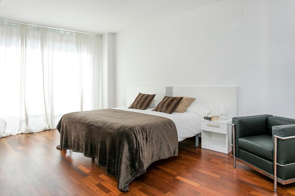 Postel nebo postele na pokoji v ubytování Glasir Apartments Barcelona
