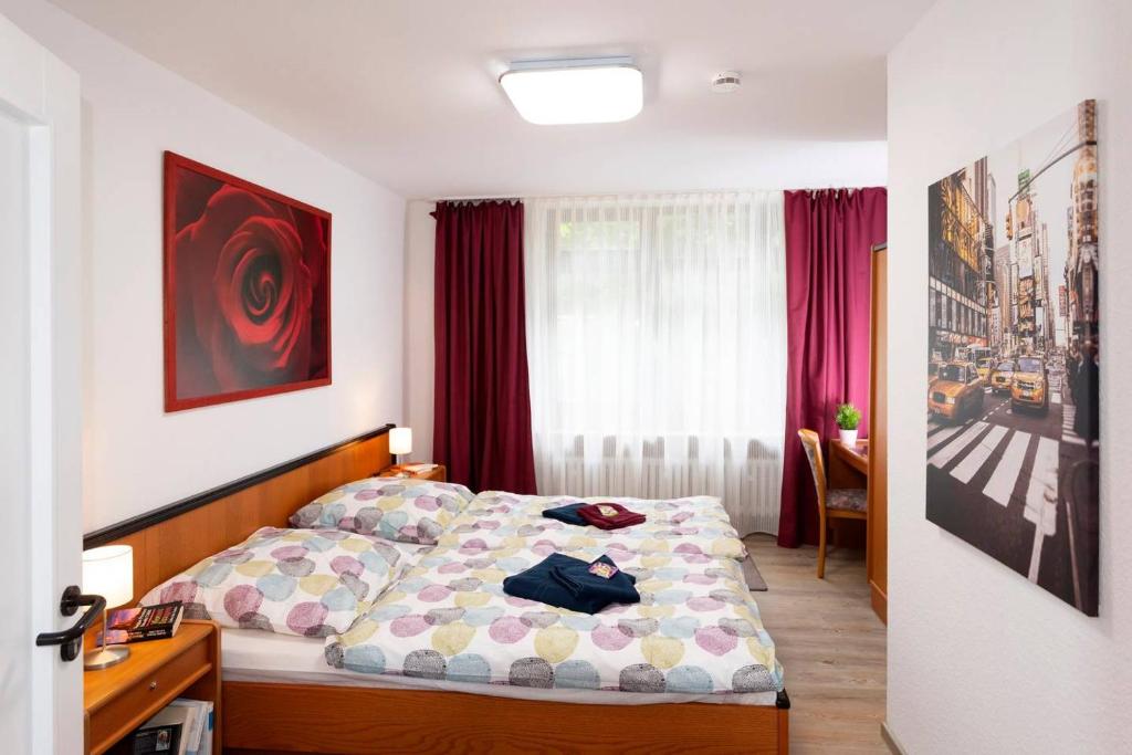 a bedroom with a bed and a table and a window at Panoramablick Appartement - traumhaft! in Ober-Hambach