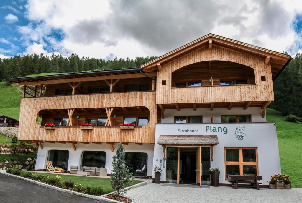 a large wooden building with a balcony at Plang Farmhouse in San Cassiano