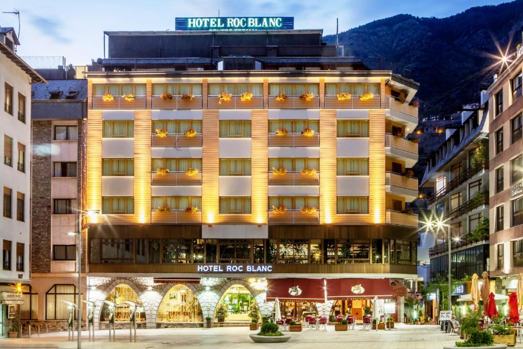 a large building with a large clock on it's side at Roc Blanc & Spa in Andorra la Vella