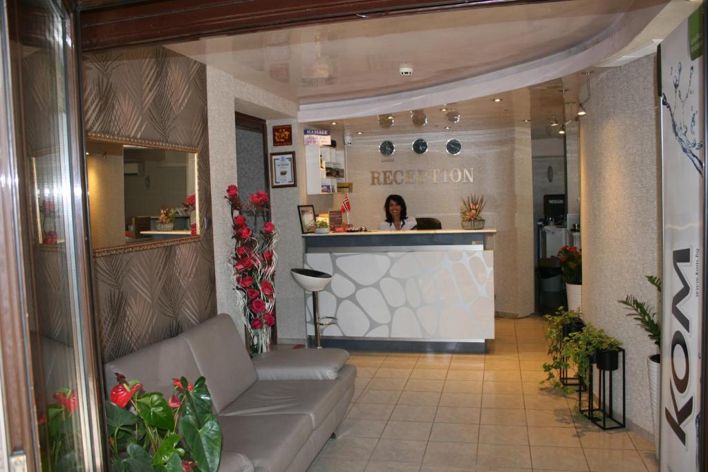 a woman in a hair salon with a counter at Hotel Perfect in Varna City