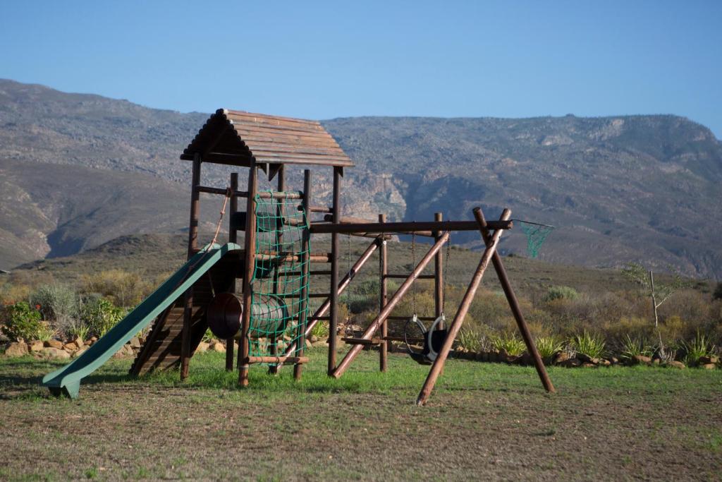 an outdoor playground with a slide and a slideintend at Windfall Wine Farm in Robertson