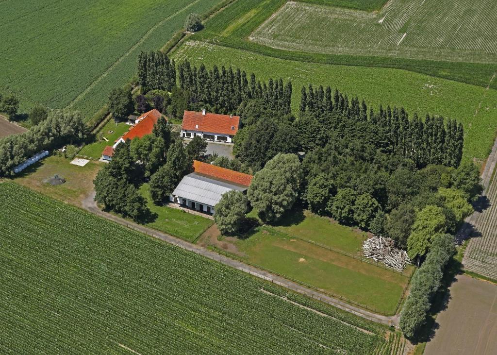 an aerial view of a house with trees at B&B Ter Castaigne in Koekelare