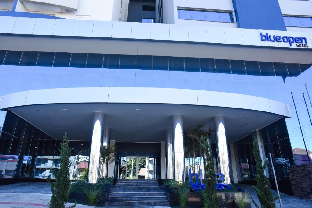 a building with a staircase in front of it at Blue Open Hotel in Erechim