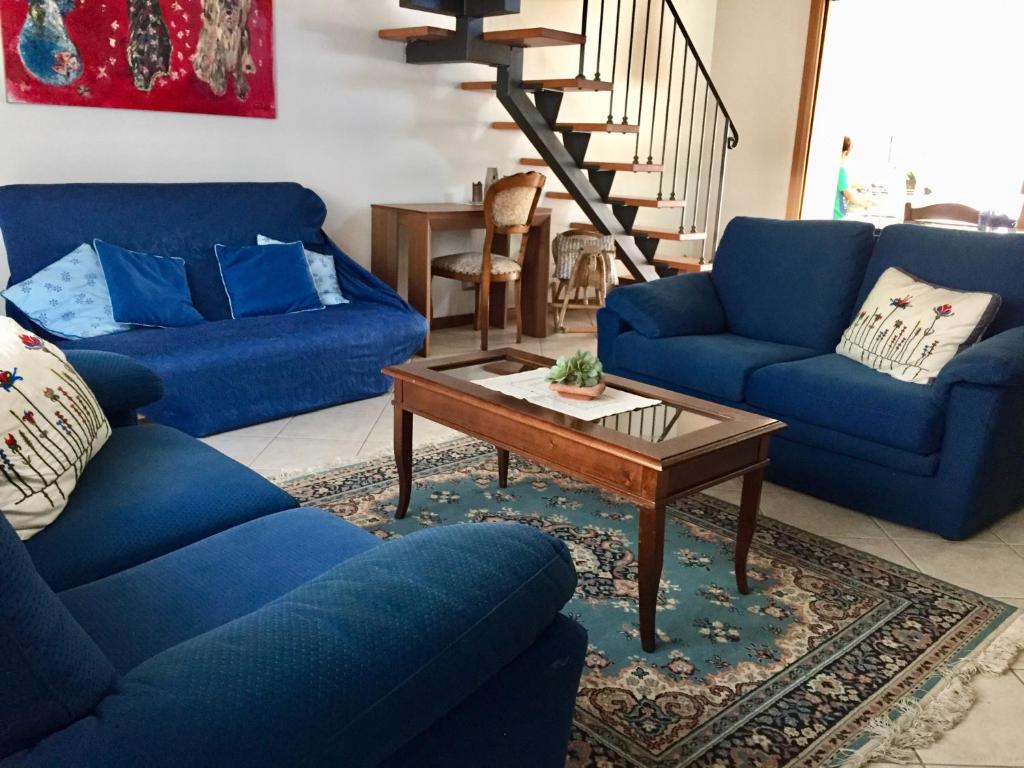 a living room with blue couches and a coffee table at My House for Florence, Airconditioned - Easy Parking in Scandicci