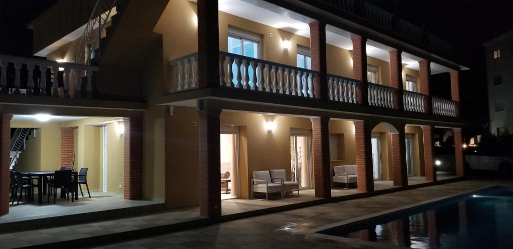 a house with a swimming pool at night at Villa Irena Denia in Denia