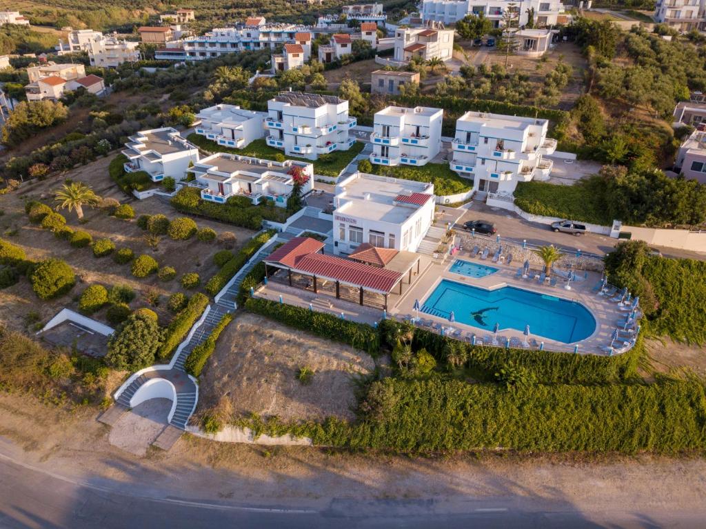 an aerial view of a house with a swimming pool at Hotel Mimoza in Agia Marina Nea Kydonias