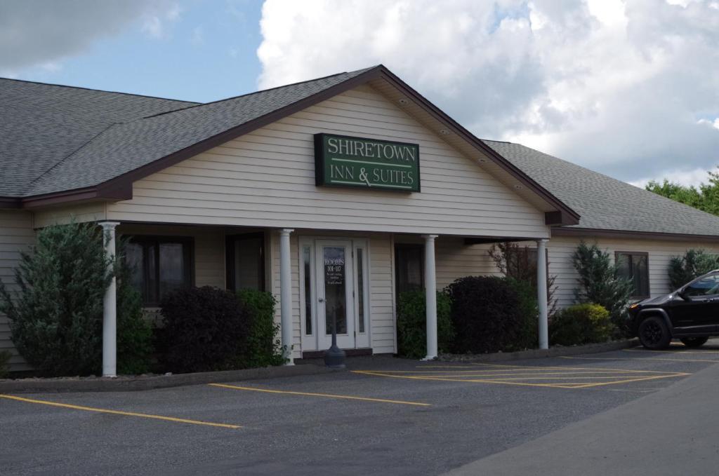 a building with a sign that reads sherborn inn and suites at Shiretown Inn & Suites in Houlton