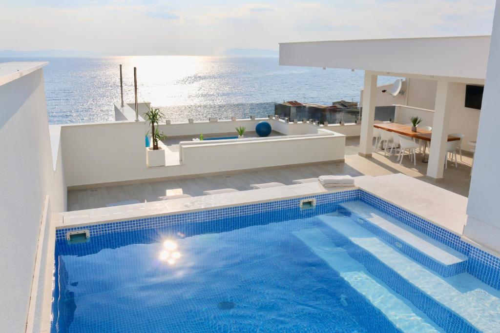 a swimming pool with a view of the ocean at Villa Mel II in Drasnice