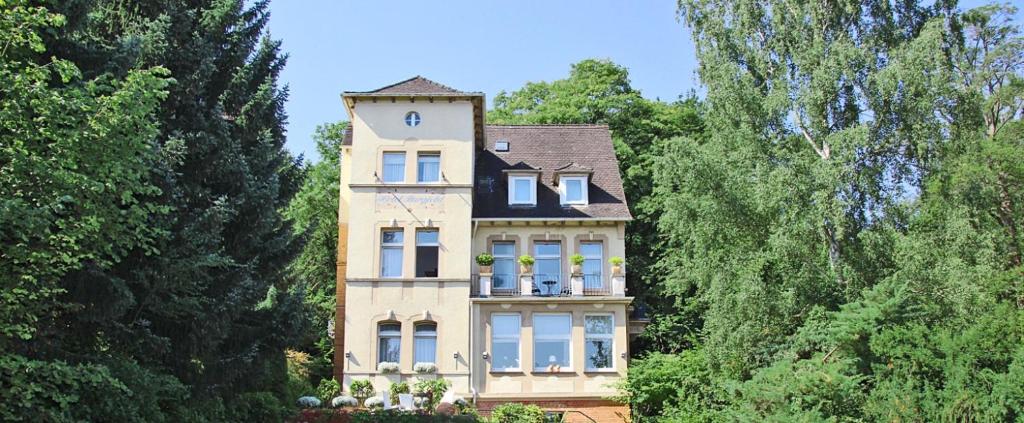 a large house with a clock on top of it at Hotel Burgfeld in Kassel