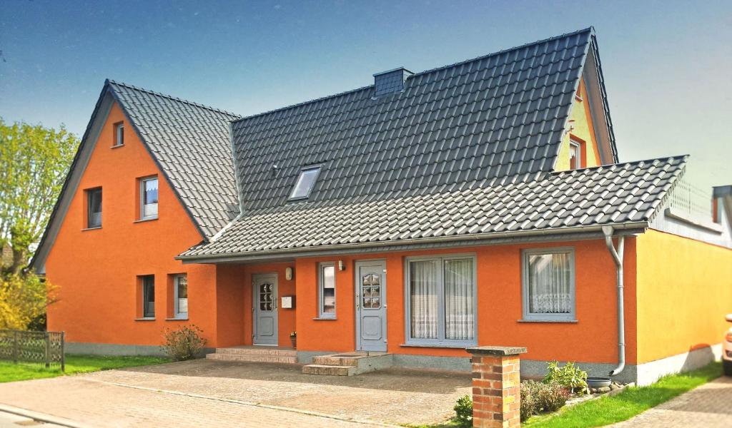 a orange house with a black roof at Ferienwohnung Zander in Zingst