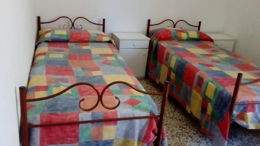 two beds sitting next to each other in a room at Casa Angelo in Santa Maria Del Focallo