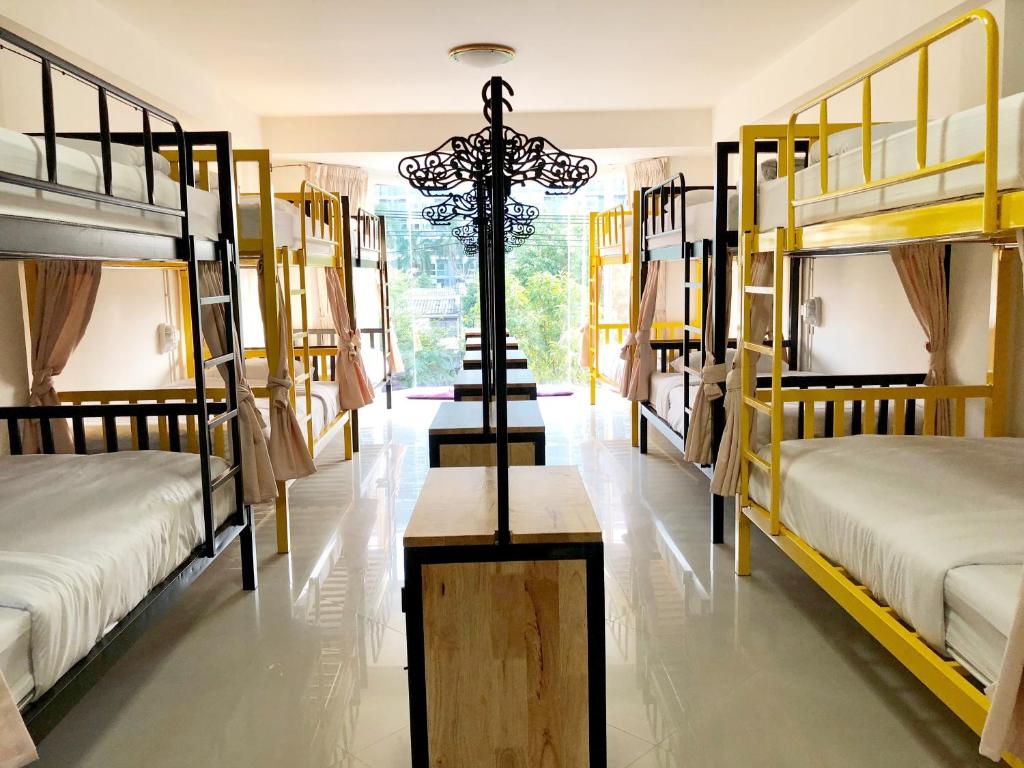 a dorm room with bunk beds and a chandelier at Daizy House in Chiang Mai