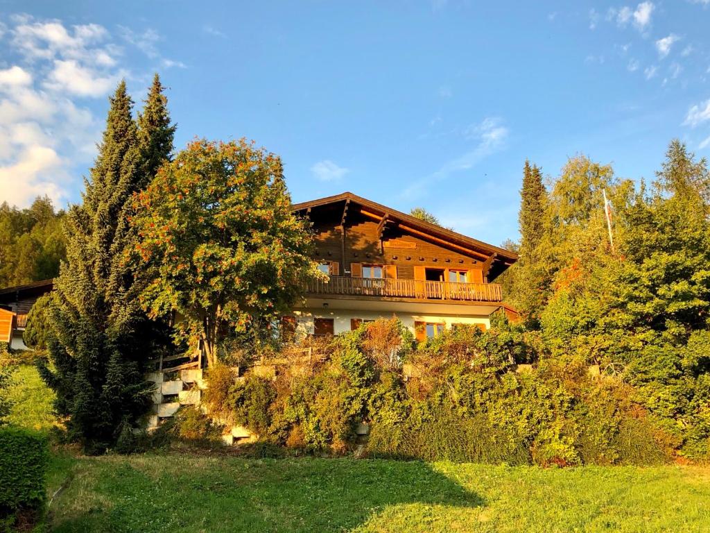 dom na zboczu wzgórza z drzewami w obiekcie Alpenchalet Trutmundi undri w mieście Eischoll