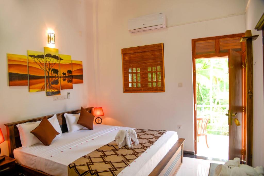 a bedroom with a bed in a room at KT Villa in Aluthgama