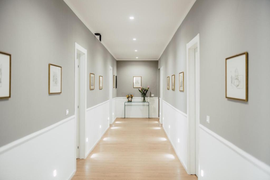 a hallway of a home with white walls and wood floors at Elysium B&B in Messina