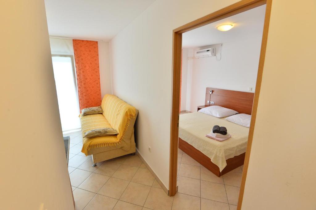 Postel nebo postele na pokoji v ubytování Apartmani Smiljanic