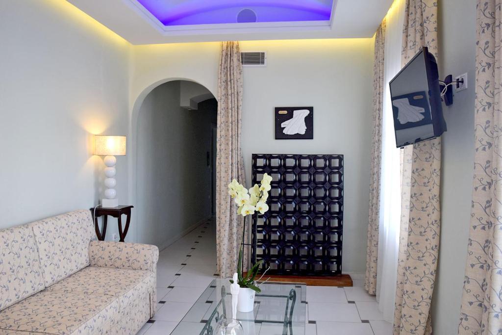 a living room with a couch and a purple ceiling at Aegialis Hotel & Spa in Aegiali