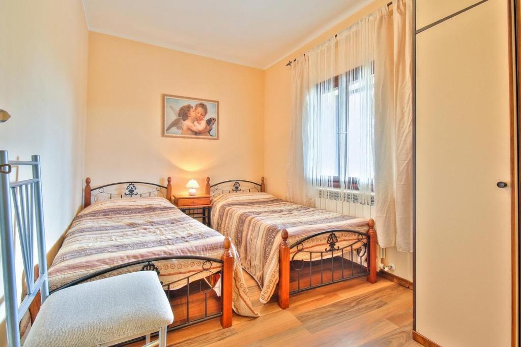 Postel nebo postele na pokoji v ubytování Lorena Apartments