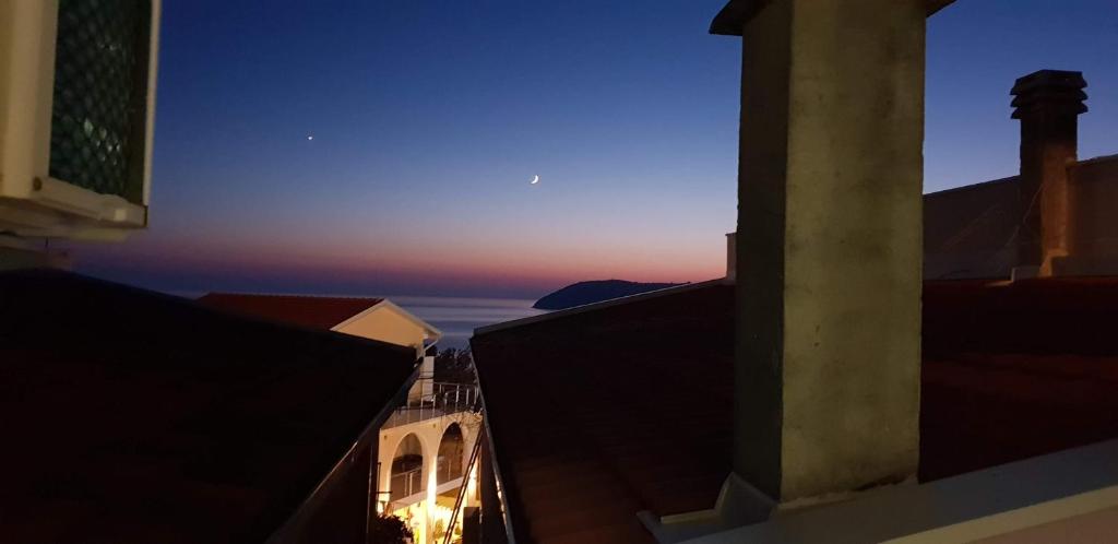 a view of the sunset from the roofs of buildings at Guesthouse Stankovic in Sutomore