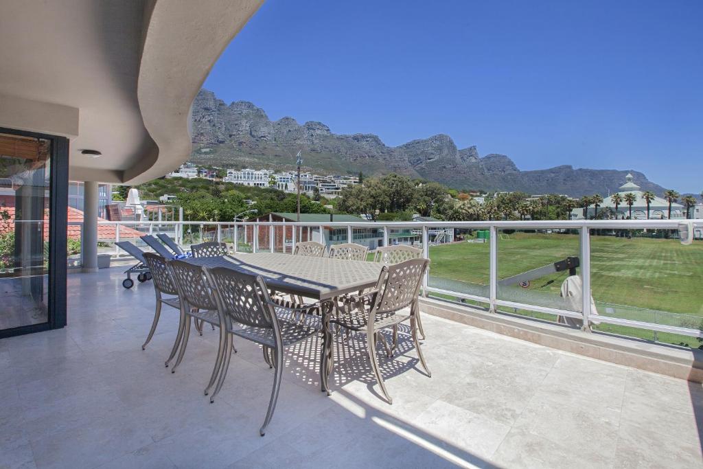 a table and chairs on the balcony of a house at position, Position, POS-ITION! Adjacent CB Beach in Cape Town