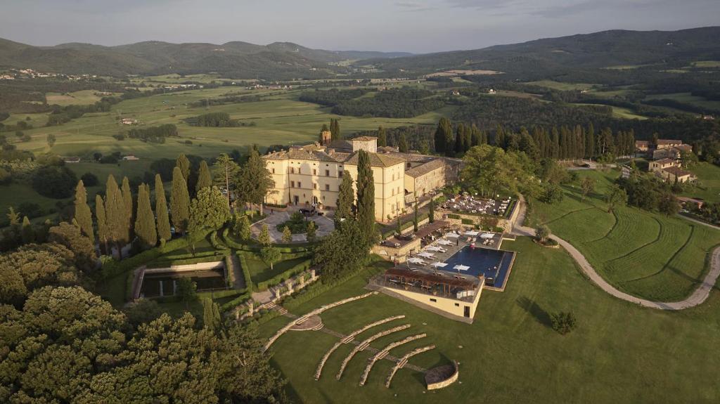 an aerial view of a large building in a field at Castello di Casole, A Belmond Hotel, Tuscany in Casole dʼElsa