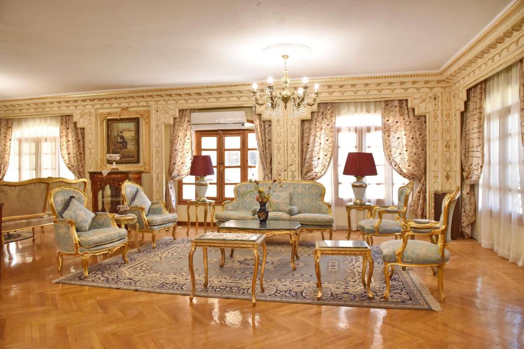 a living room with chairs and a table at Royal Residence Families Only in 6th Of October