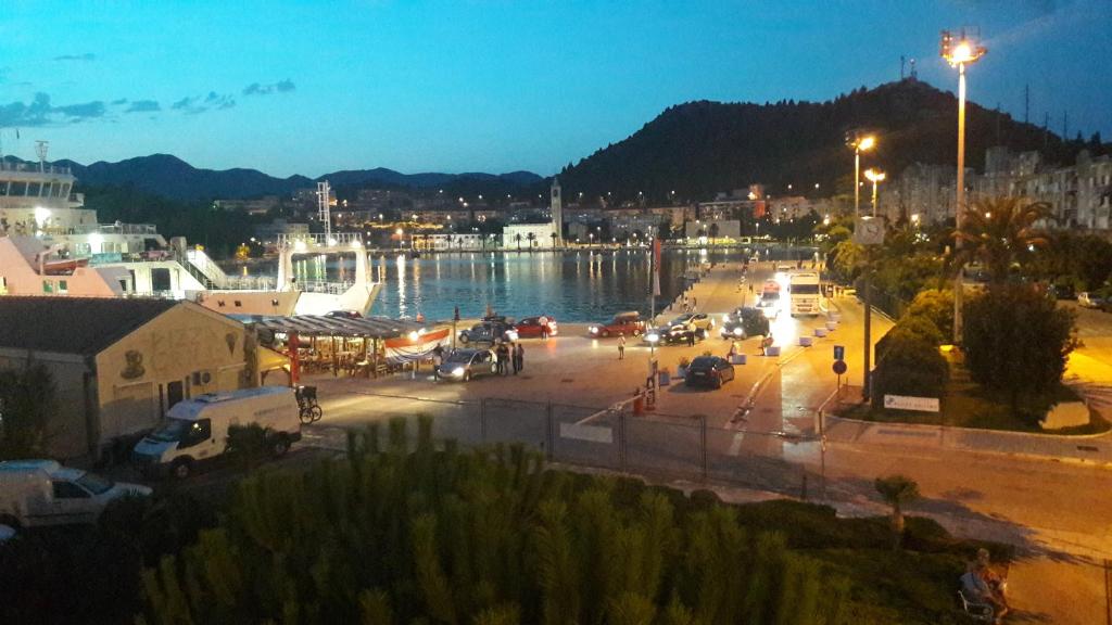 a view of a city at night with a harbor at Apartman Sanja in Ploče